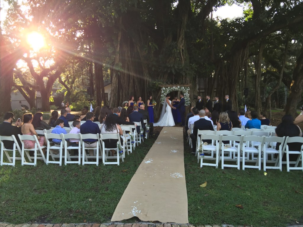 Outdoor wedding ceremony with DJ setup and dancing guests