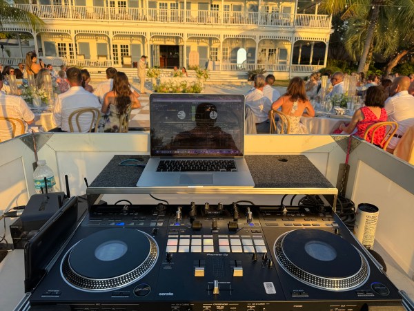 DJ console performing for guests at an outdoor reception
