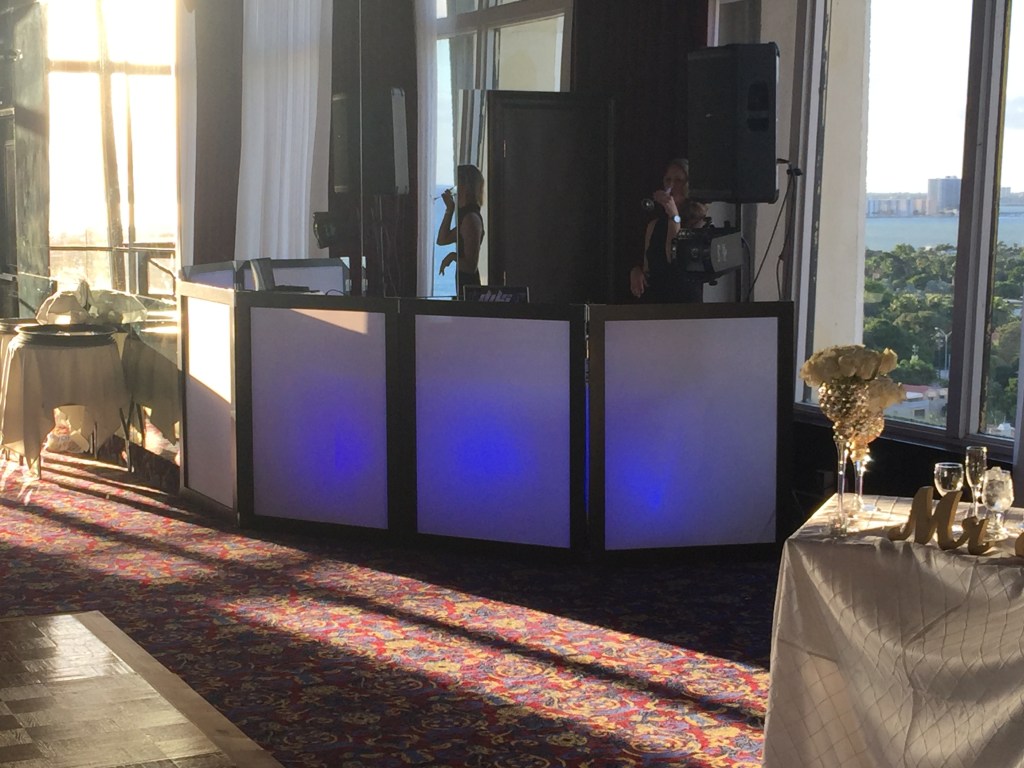 Indoor DJ booth with illuminated panels and speaker
