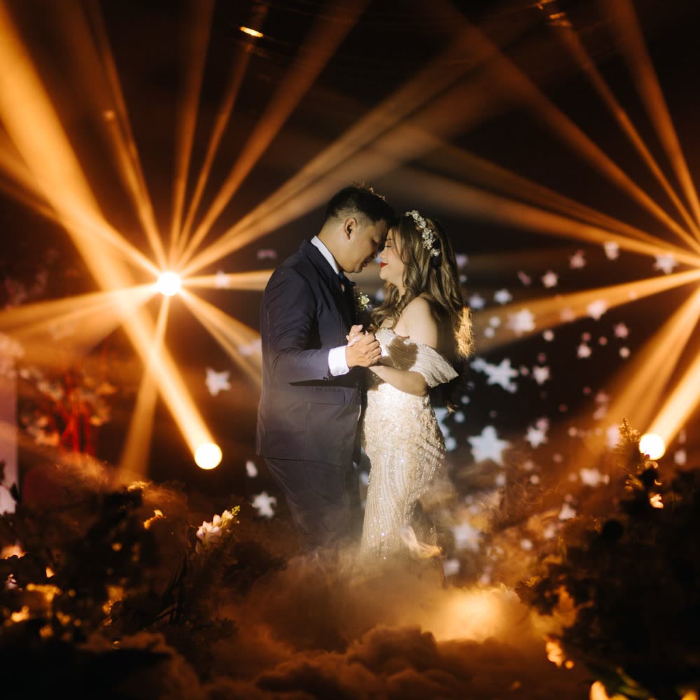 Moving light beams over a couple's first dance