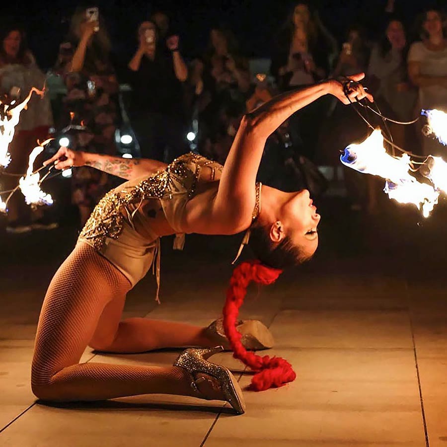 Fire performer with flaming props