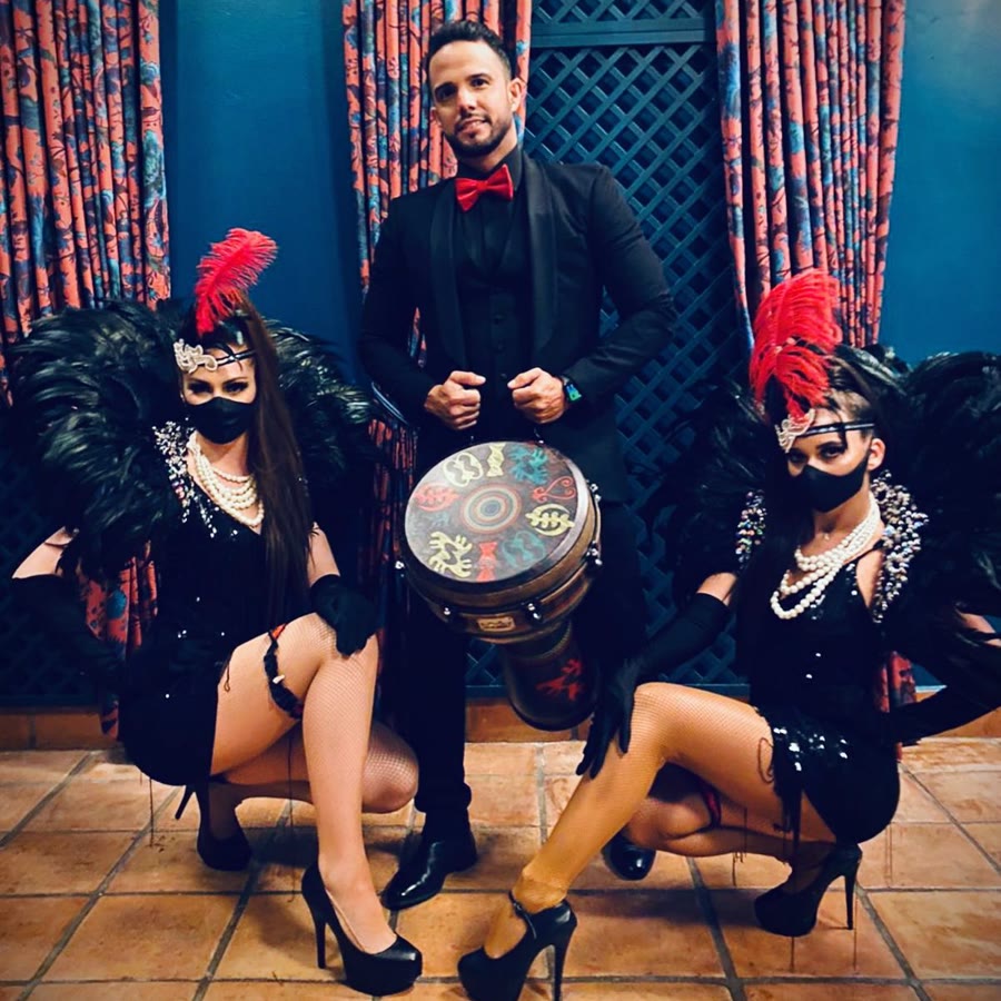 Live percussionist and Hora Loca feather dancers performing alongside the DJ