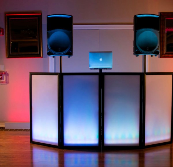 DJ facade with speakers in a ballroom with color uplighting