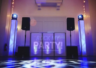 Rock My Party DJ booth with light towers, moving heads and gobo dance floor