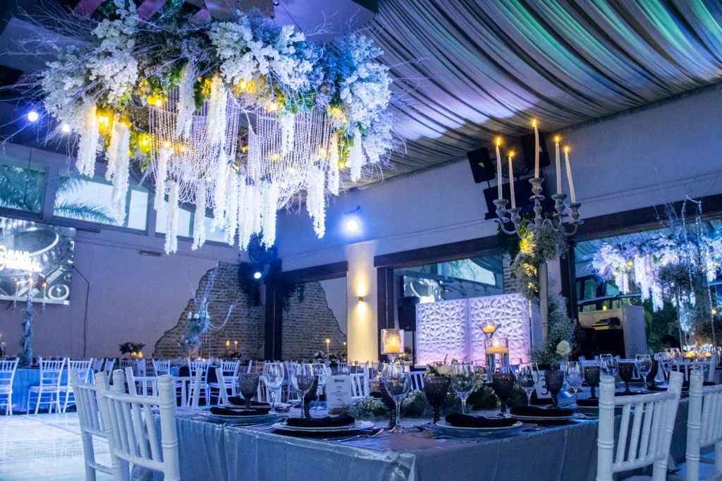 Luxury wedding reception with dramatic blue and purple uplighting